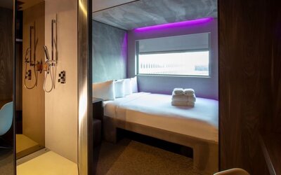 Day use room with work desk, private bathroom and window with view to the airport at Bloc Hotel.