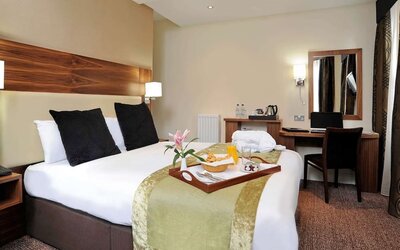 King bed with work desk at Mercure London Bloomsbury.