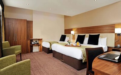 Day use twin room with work desk and lounge seating at Mercure London Bloomsbury.