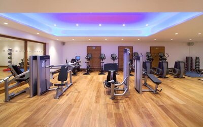 Fully equipped fitness center at Leonardo Royal Hotel London Tower Bridge.