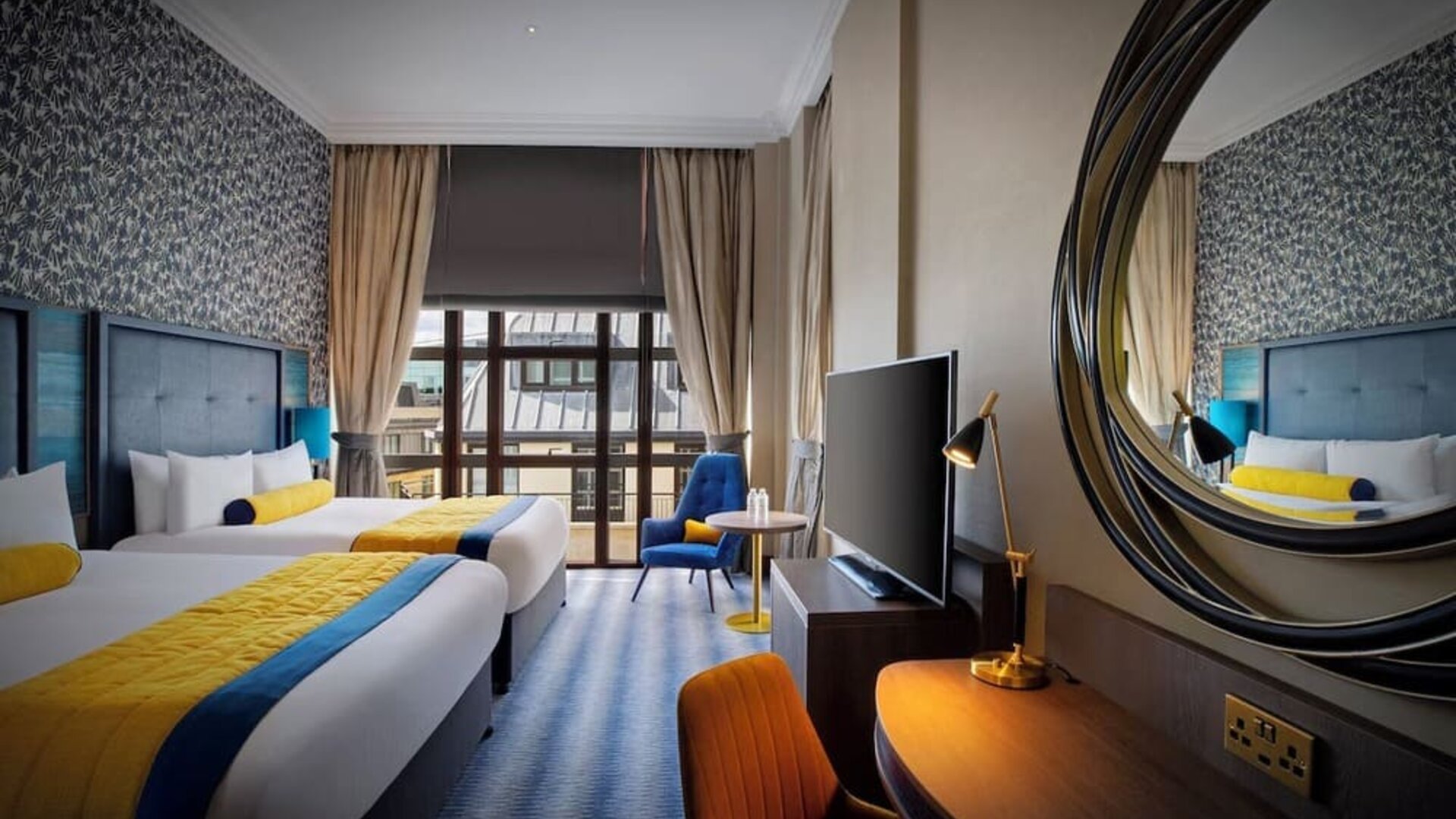 Day use twin room with TV screen, work desk and lounge seating at Leonardo Royal Hotel London City.