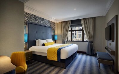 Day use room with work desk and TV screen at Leonardo Royal Hotel London City.