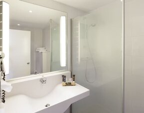 Private guest bathroom with free toiletries at Novotel Manchester West.