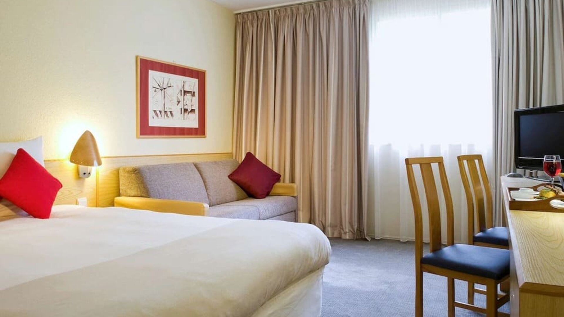 Day use room with work desk and sofa at Novotel Manchester West.