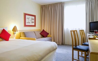 Day use room with work desk and sofa at Novotel Manchester West.