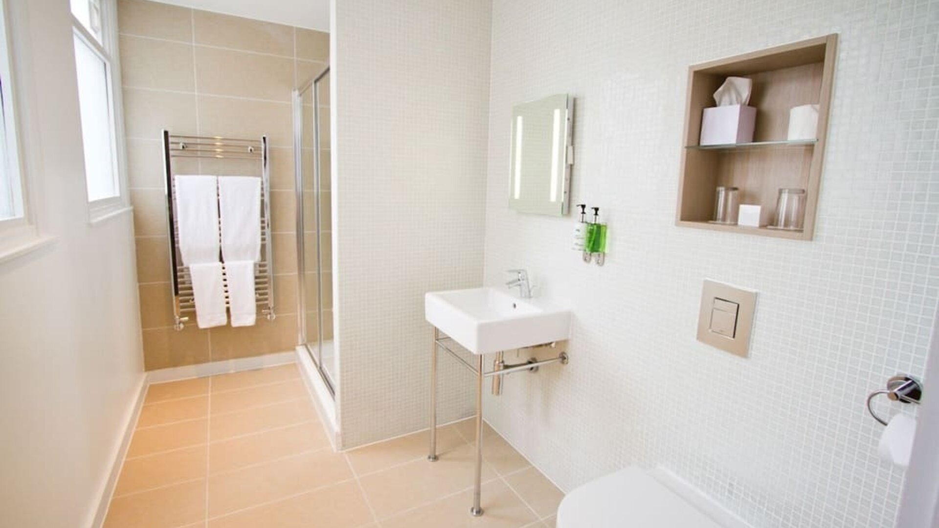 Guest bathroom with shower and free toiletries at The Wesley Euston Hotel.