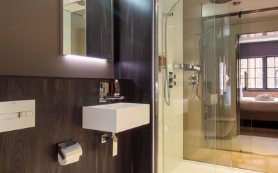Guest bathroom with shower and free toiletries at Bloc Hotel Birmingham.