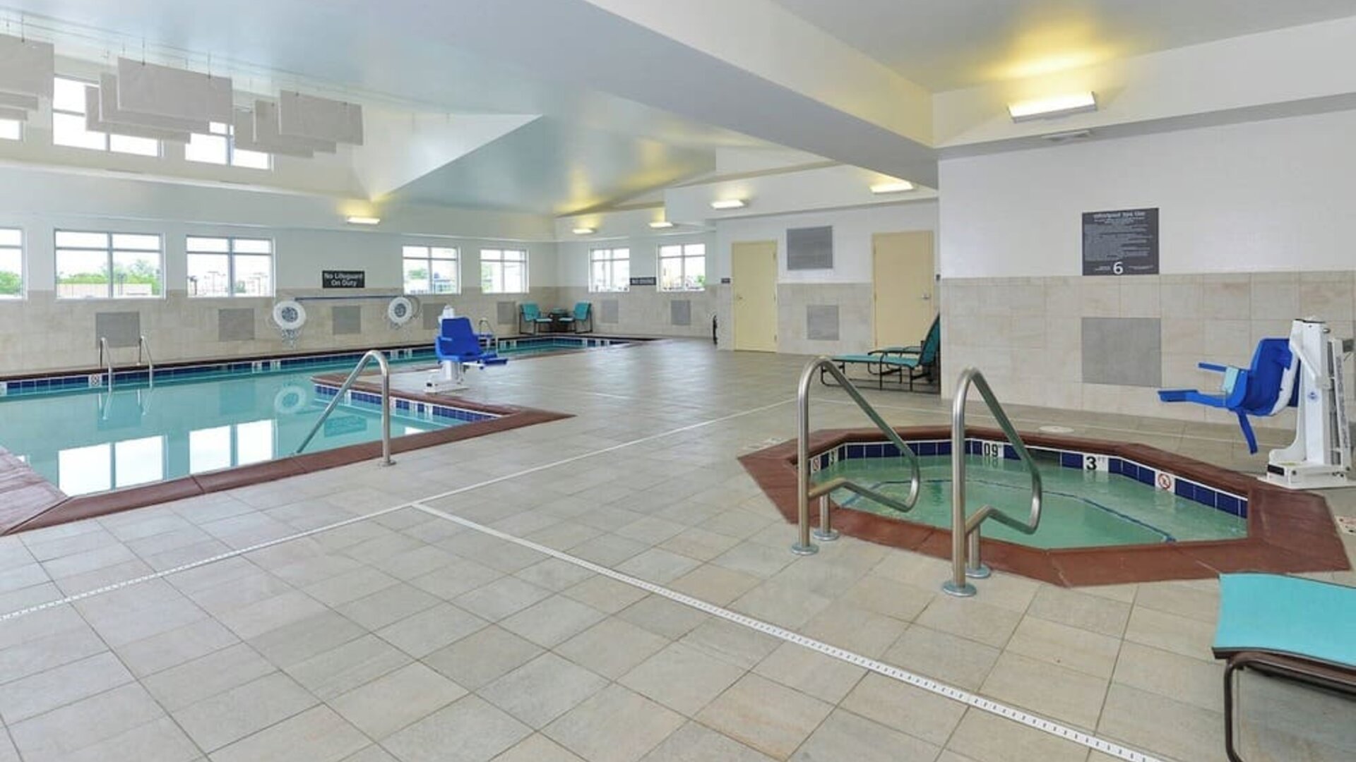 Indoor pool and spa tub at Residence Inn Champaign.