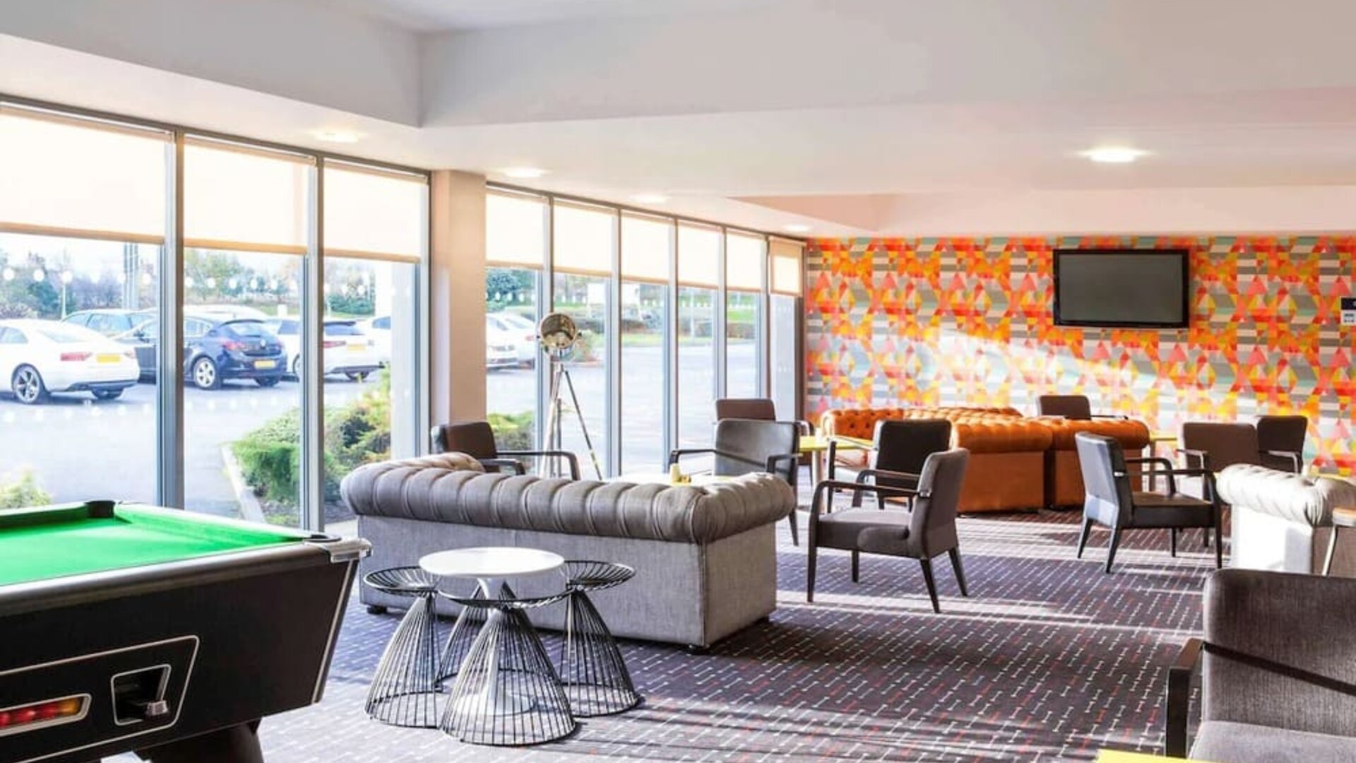 Lobby lounge with comfortable seating and billiards at Ibis Styles Barnsley.