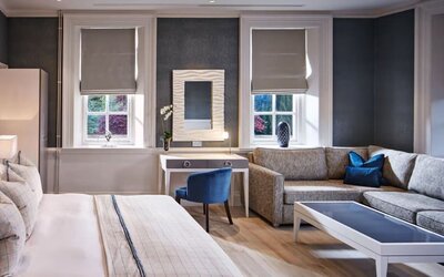 Day use studio suite with work desk and living area at Barnett Hill Hotel.