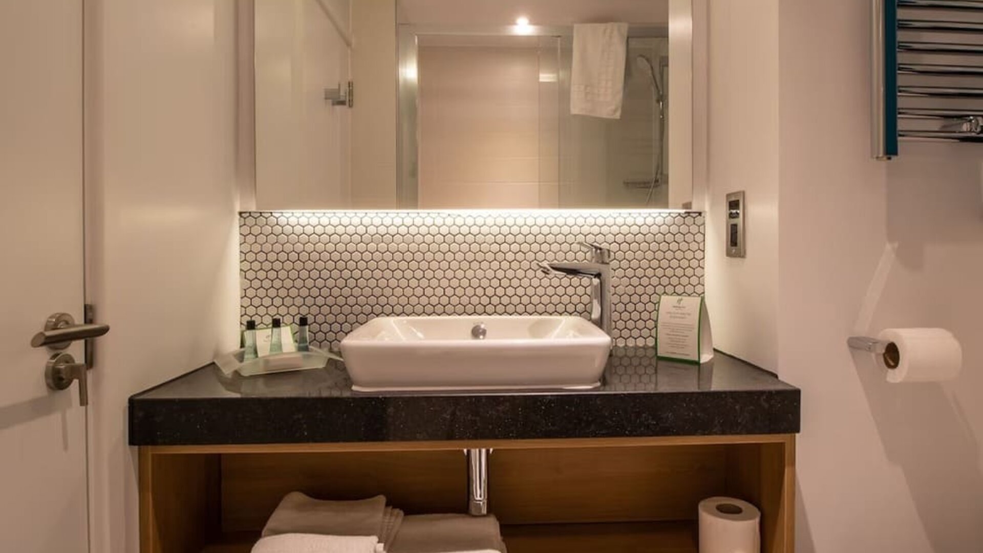 Guest bathroom with shower and free toiletries at Holiday Inn Leicester-Wigston.