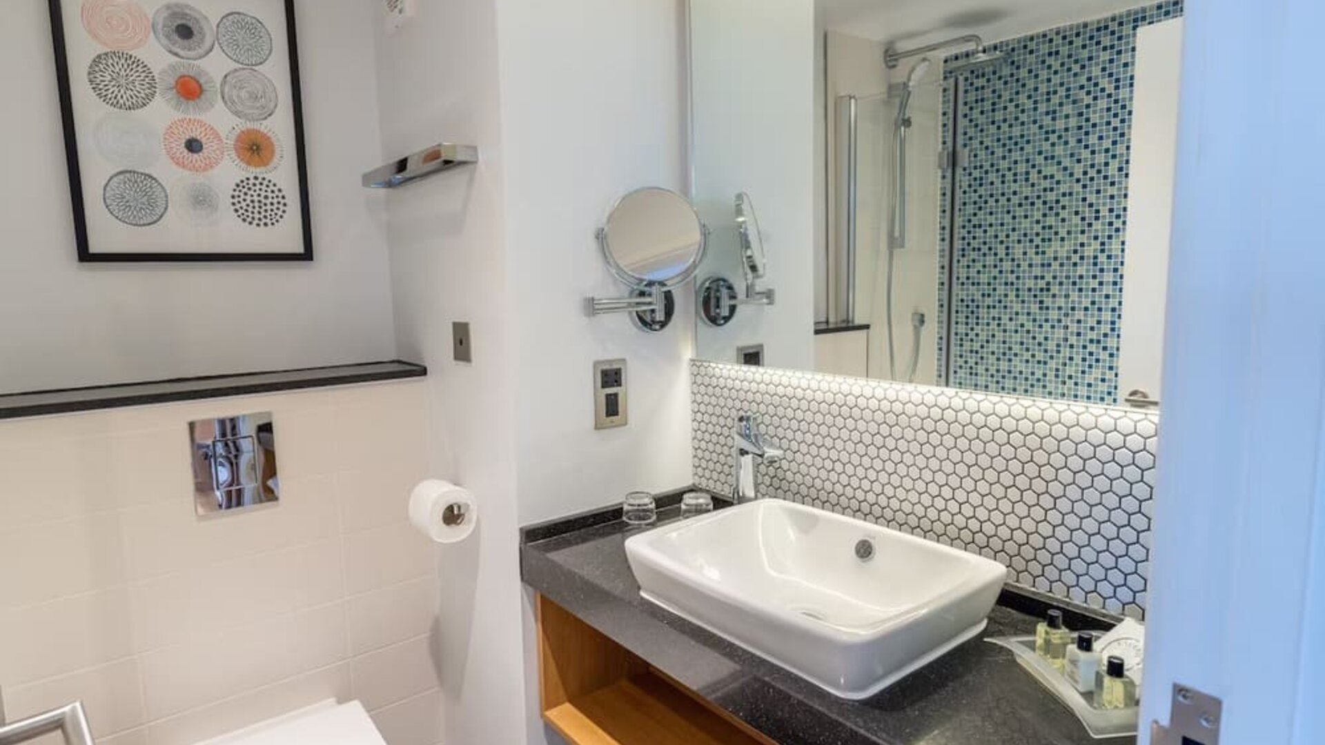 Guest bathroom with shower and free toiletries at Holiday Inn Leicester-Wigston.