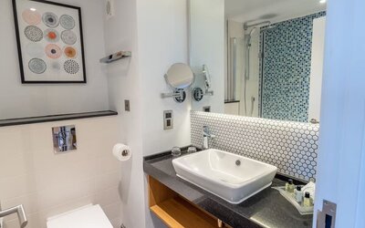 Guest bathroom with shower and free toiletries at Holiday Inn Leicester-Wigston.