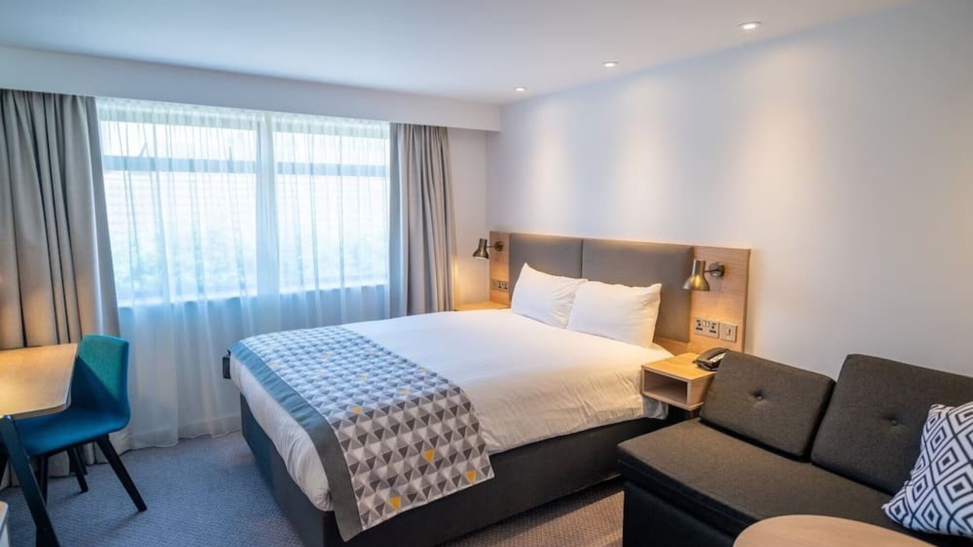 Day use room with work desk and lounge area at Holiday Inn Leicester-Wigston.