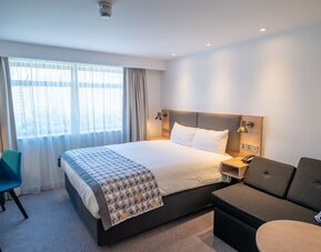 Day use room with work desk and lounge area at Holiday Inn Leicester-Wigston.