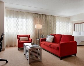 Day use room with sofa and work desk at Renaissance Newark Airport Hotel.