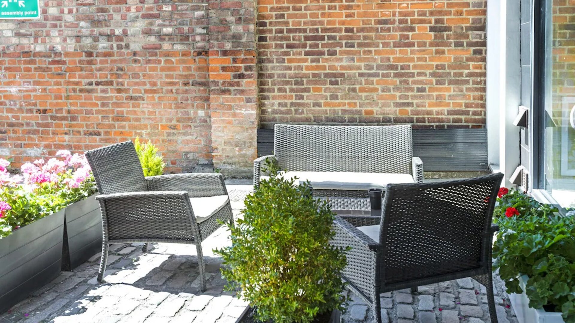 Outdoor patio with lounge seating at Hotel Shepherds Bush London.