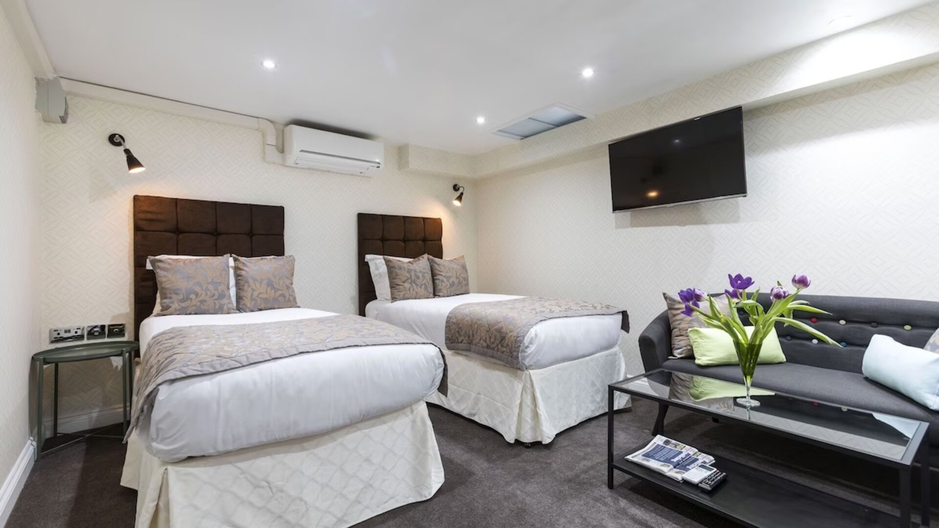 Day use family suite with two beds and lounge area at Hotel Shepherds Bush London.