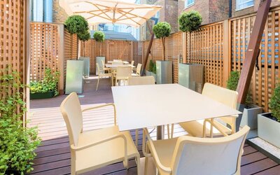 Beautiful outdoor patio with sitting area at Indigo London-Paddington Hotel.