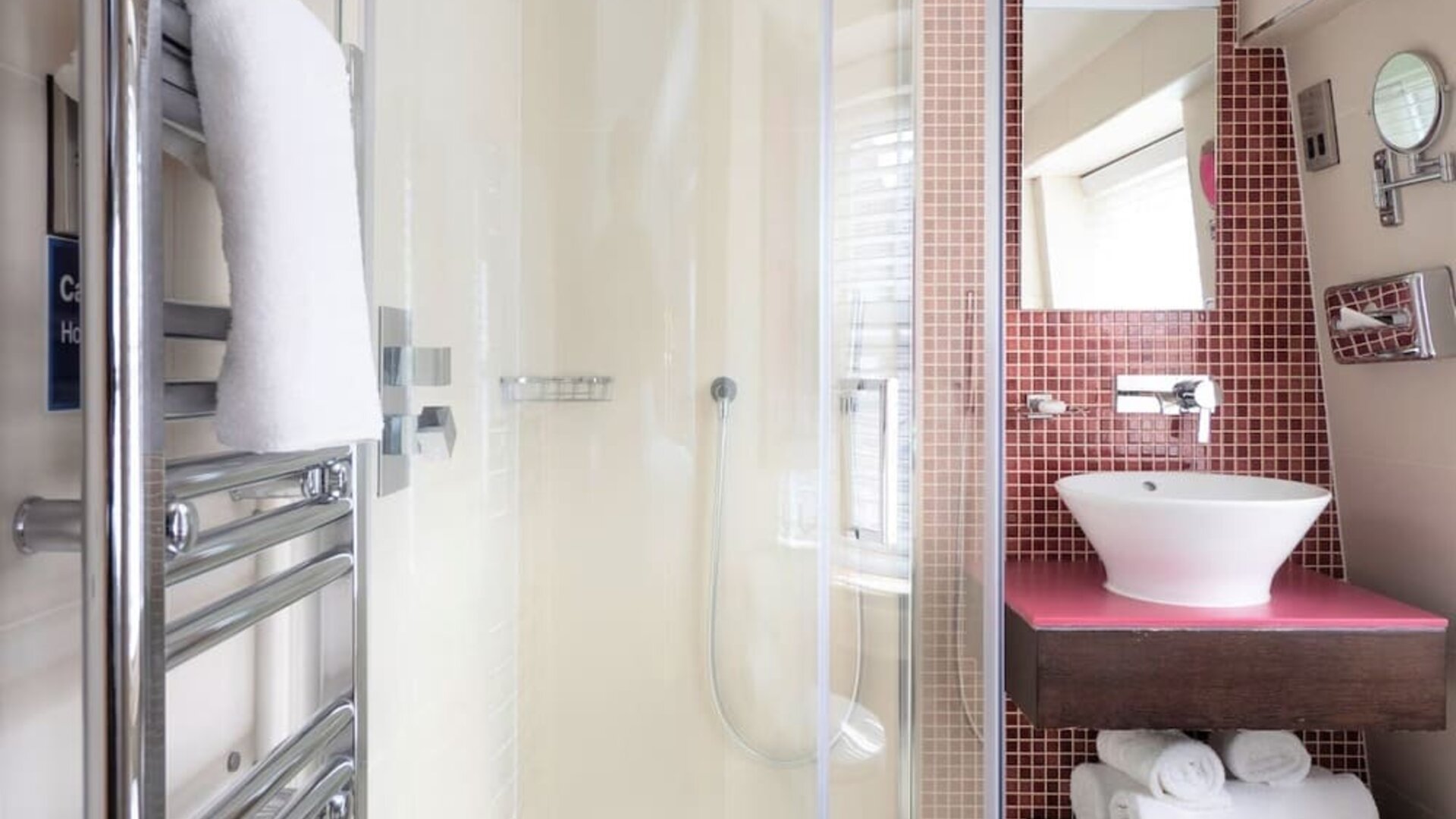 Private guest bathroom with shower and free toiletries at Indigo London-Paddington Hotel.
