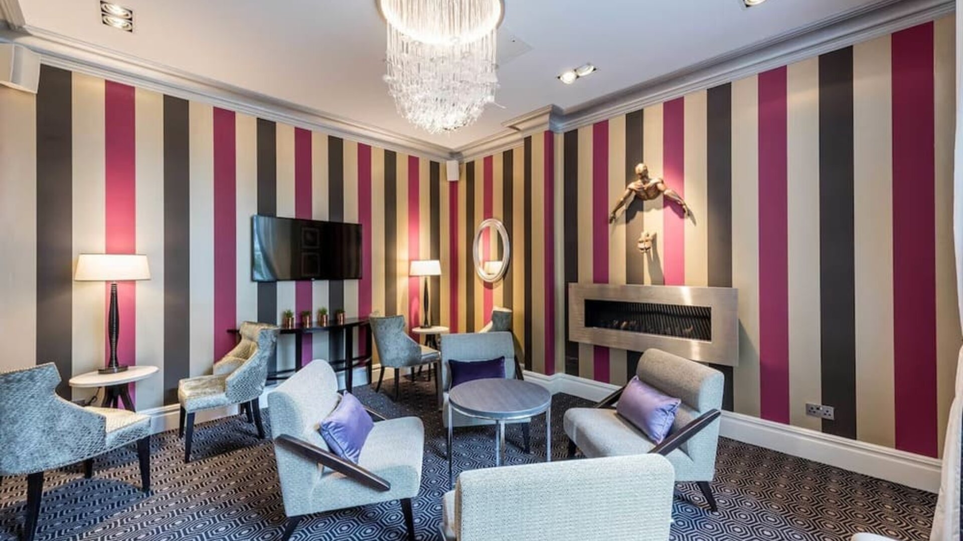 Lounge area with comfortable seating and fireplace at Mercure London Hyde Park Hotel.