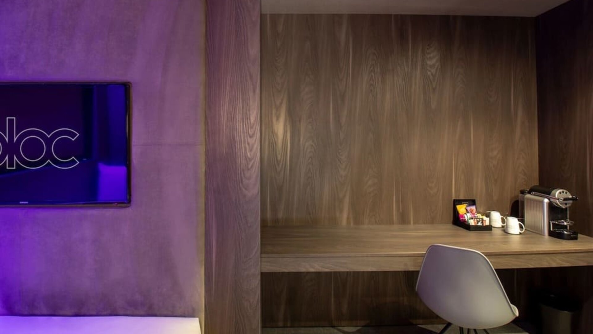 In-room workspace with comfortable seating and coffee maker at BLOC Gatwick Hotel.