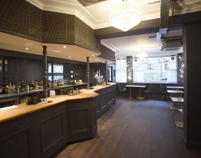 Hotel bar with sitting area at The Pack And Carriage London Hotel.