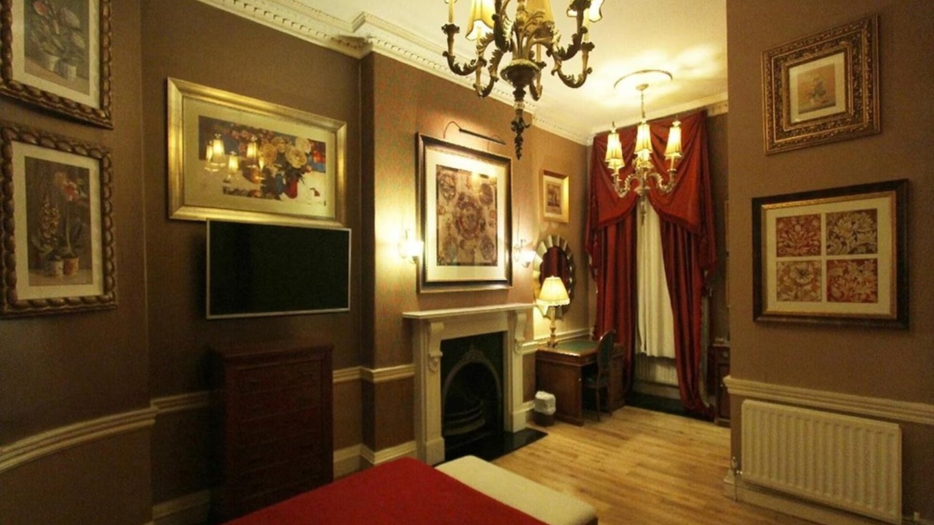 Day use room with work desk and fireplace at Opulence Central London Hotel.