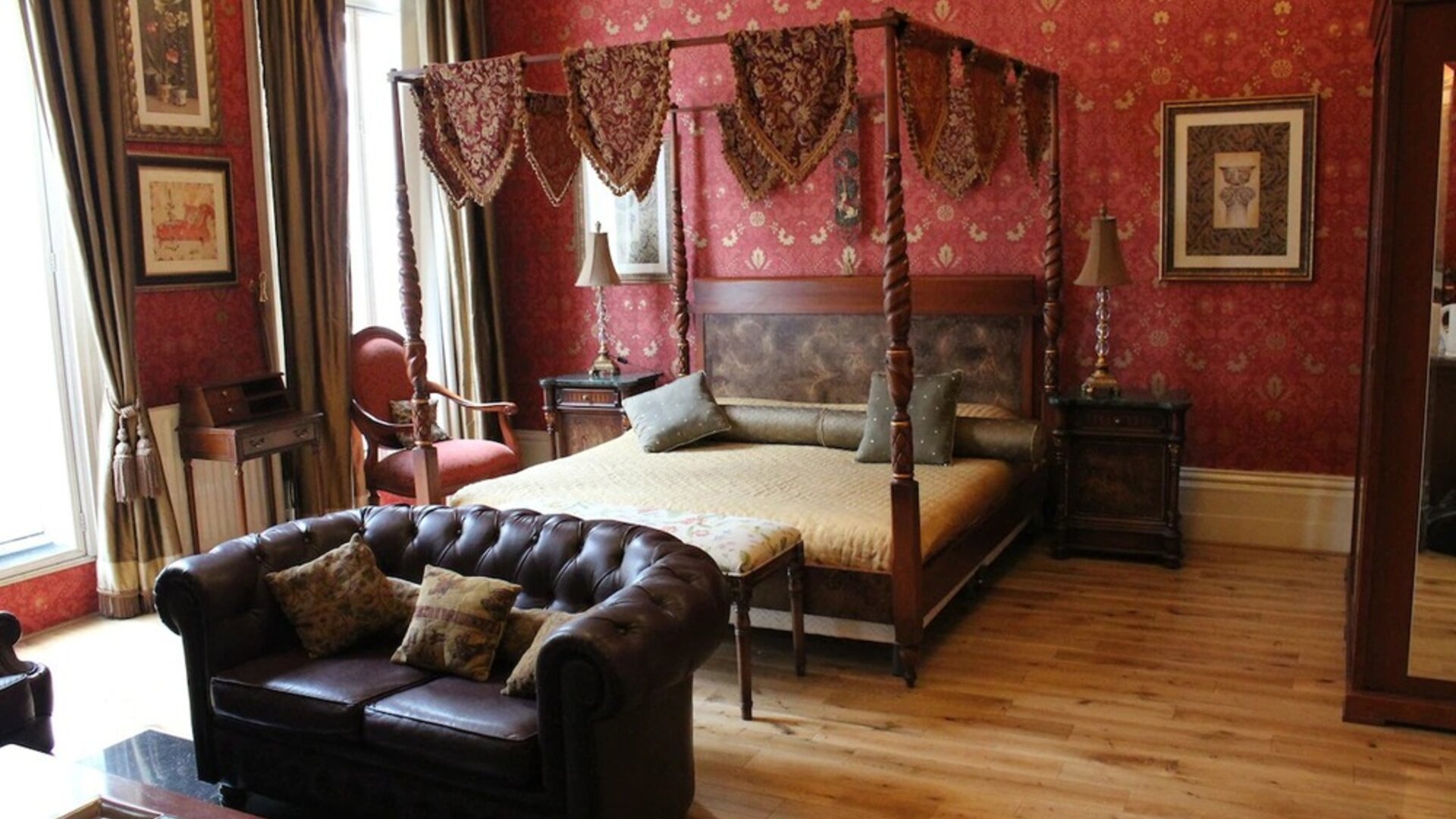 Day use suite with king bed, floor to ceiling windows, living area with fireplace and private bathroom at Opulence Central London Hotel.