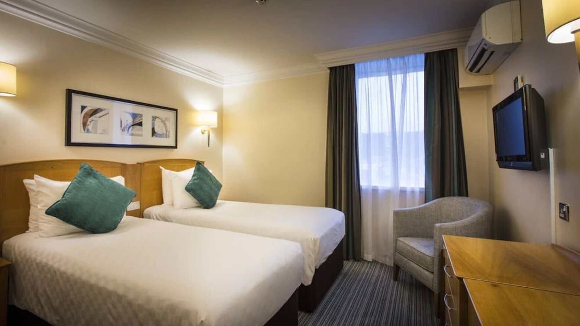 Day use twin room wth work desk and lounge seating at Thistle London Heathrow Terminal 5 Hotel.