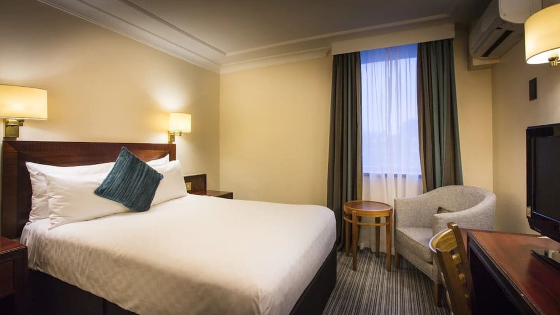 Day use room with work desk and lounge seating at Thistle London Heathrow Terminal 5 Hotel.
