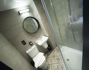 Guest bathroom with shower at The House Of Toby Hotel.