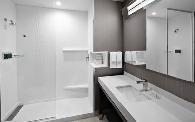 Guest bathroom with shower at Courtyard Delray Beach.
