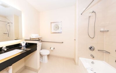 Guest bathroom with shower at Best Western San Diego Zoo/SeaWorld Inn & Suites.