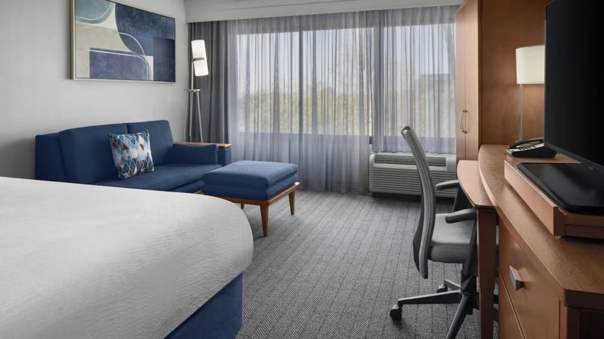 Day use room with sofa and work desk at Courtyard By Marriott Cypress Anaheim.
