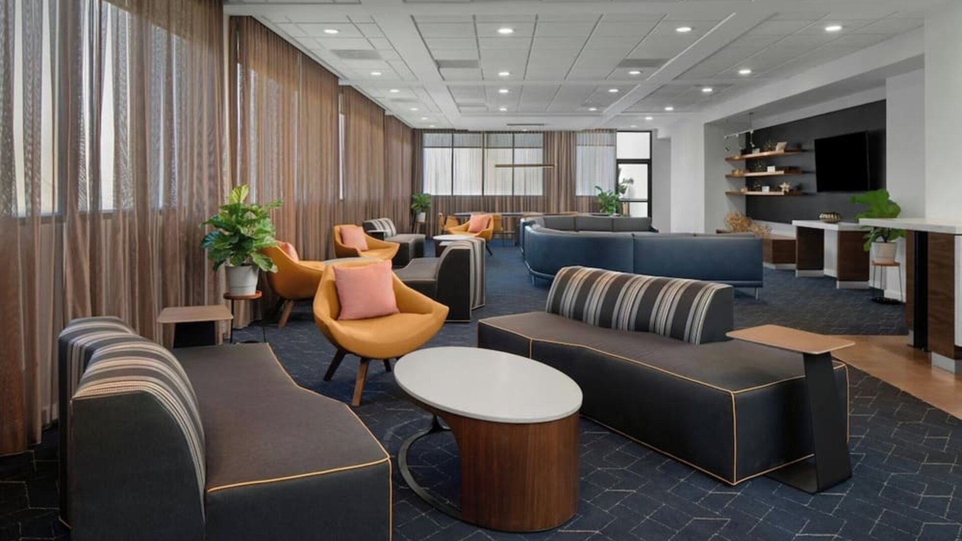 Lobby and coworking lounge at Courtyard By Marriott Cypress Anaheim.