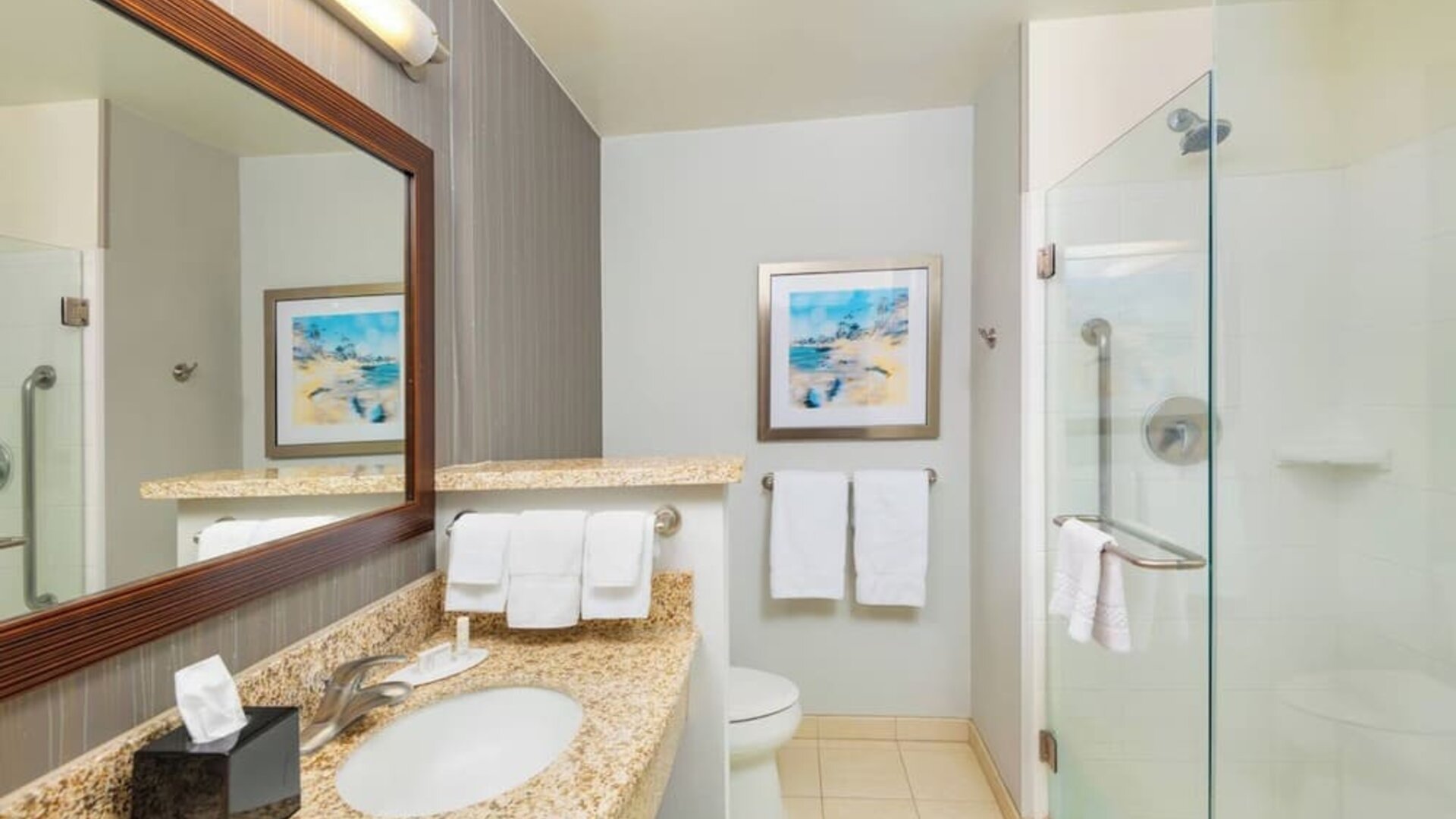 Guest bathroom with shower at Courtyard By Marriott Santa Ana Orange County.