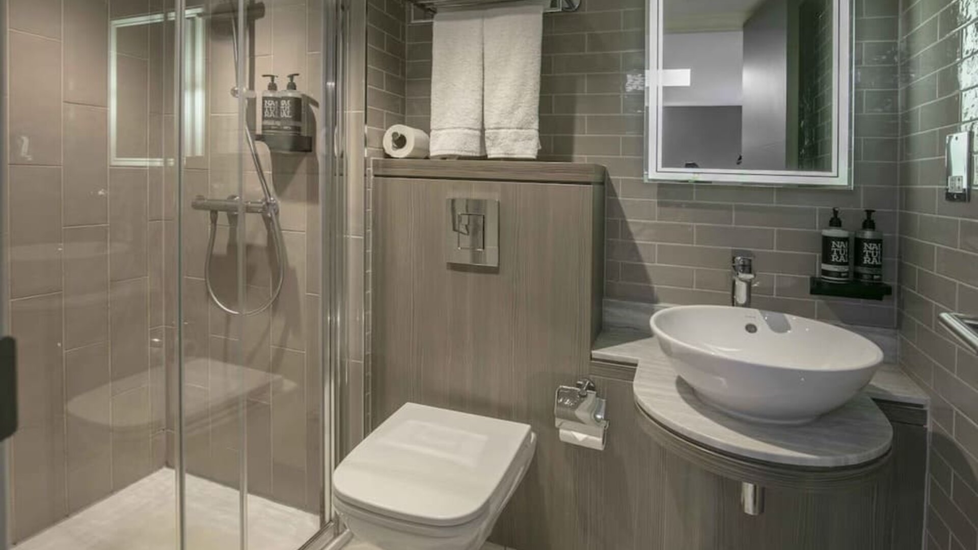 Guest bathroom with shower at Best Western Plus Vauxhall Hotel.