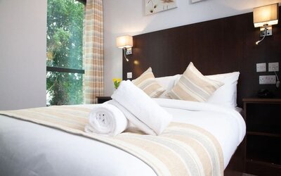 King bed at London City Airport Hotel.