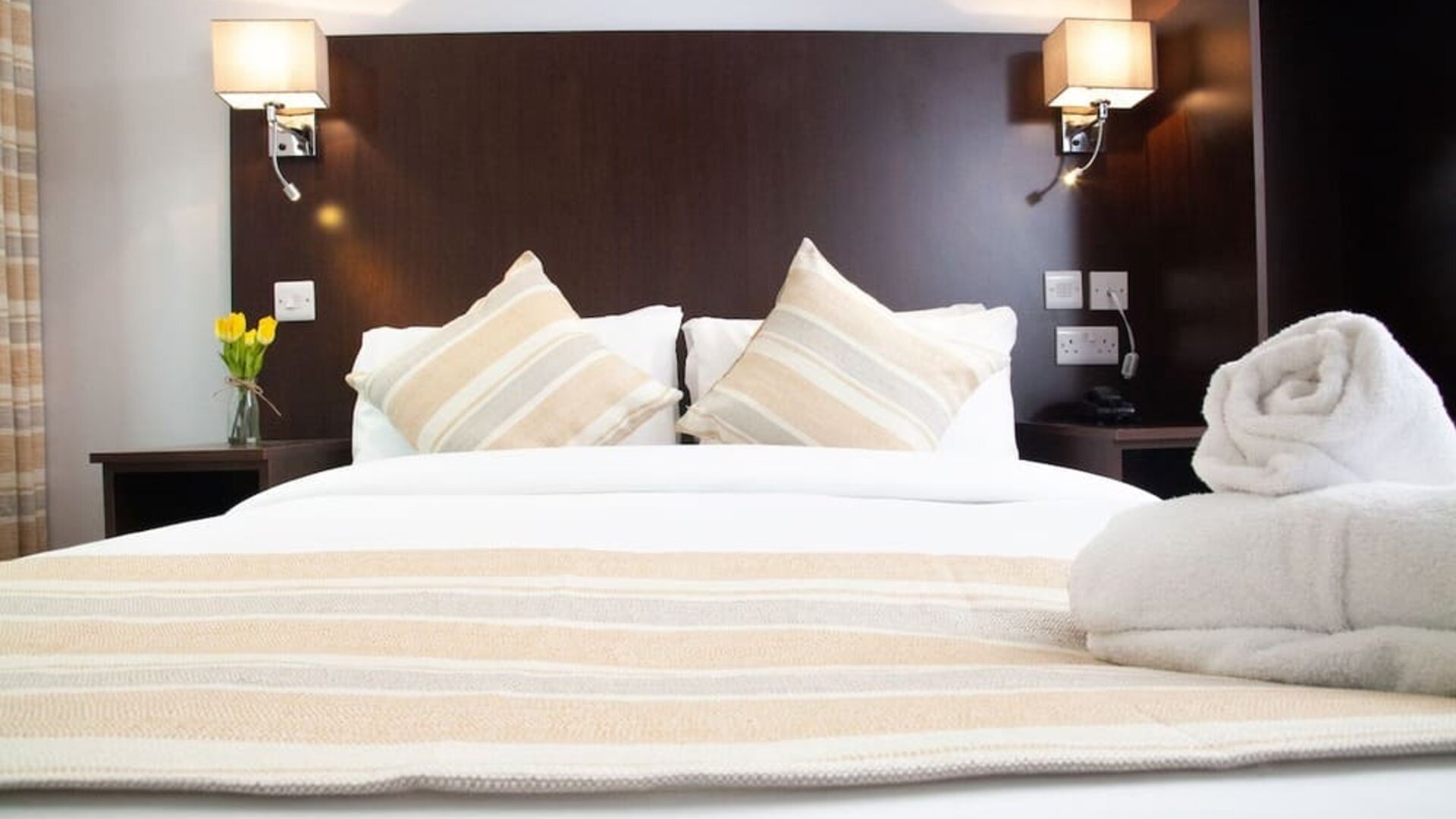 Comfortable king bed at London City Airport Hotel.