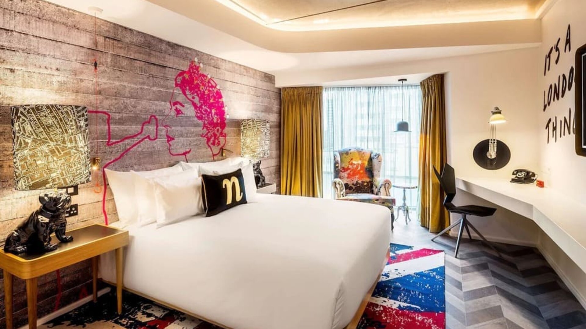 Bright and spacious day use room with floor to ceiling window and work desk at nhow London.