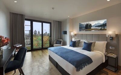 Day use room with floor to ceiling window and work desk at Tower Suites Hotel by Blue Orchid.