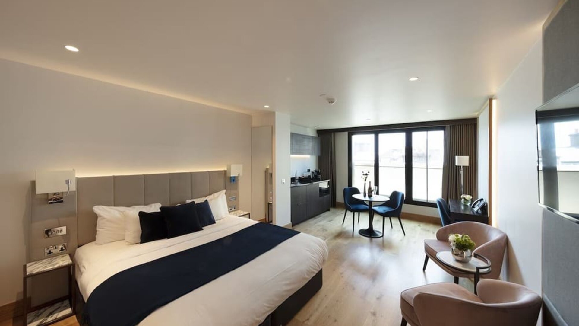 Day use executive suite with in-room kitchen, lounge seating and workspace at Tower Suites Hotel by Blue Orchid.