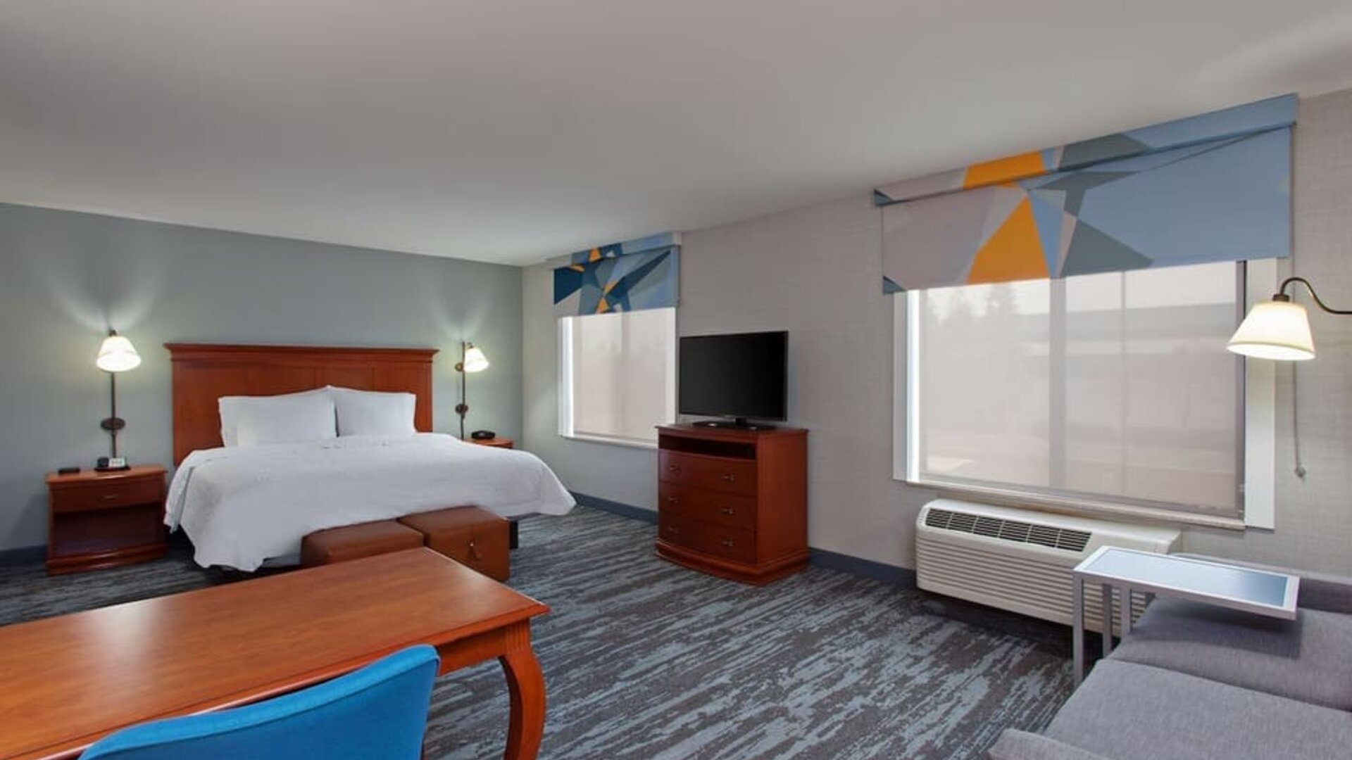 Day use room with work desk and sofa at Hampton Inn & Suites Clovis.