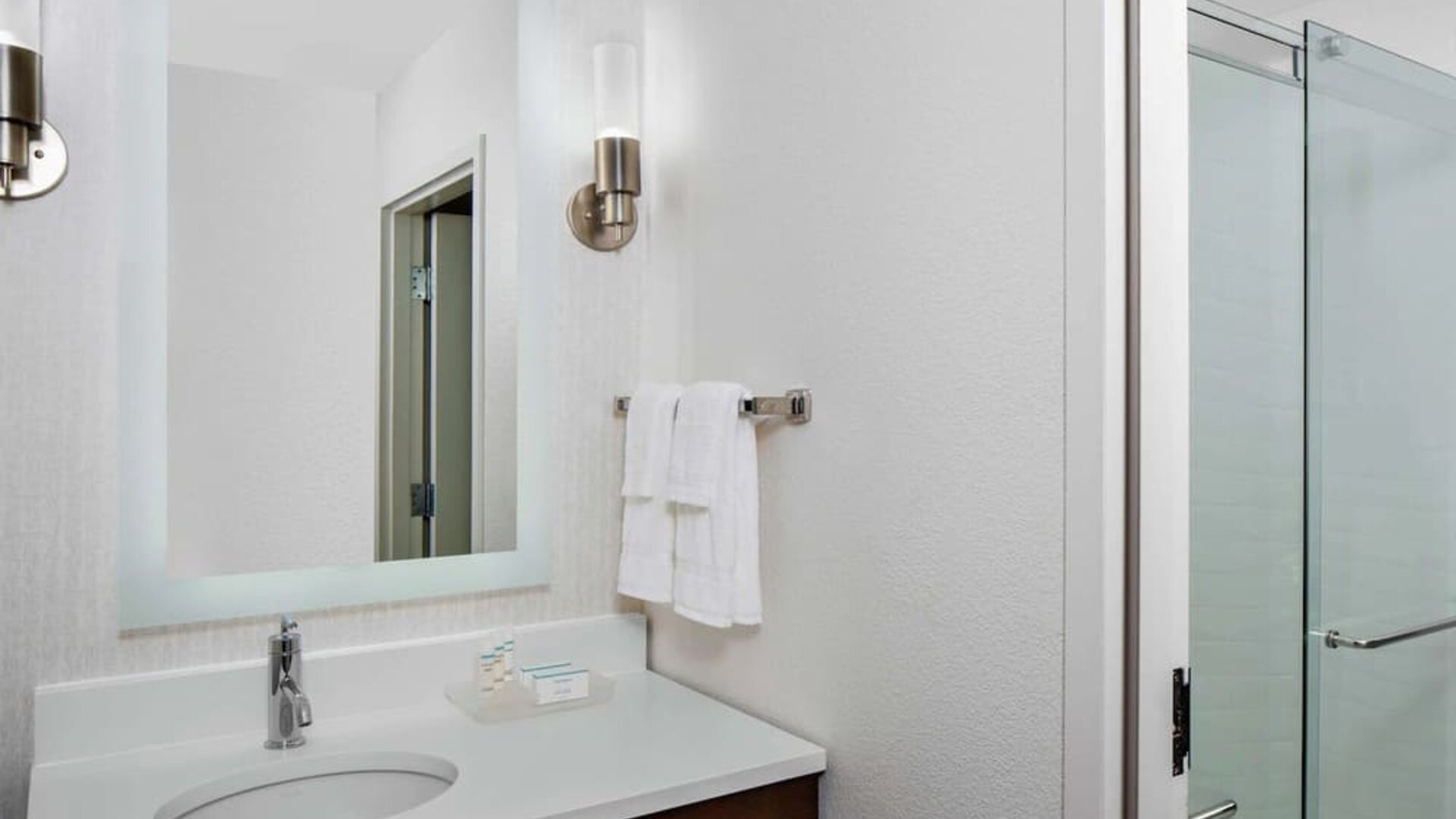 Guest bathroom with shower at Homewood Suites By Hilton Nashville.