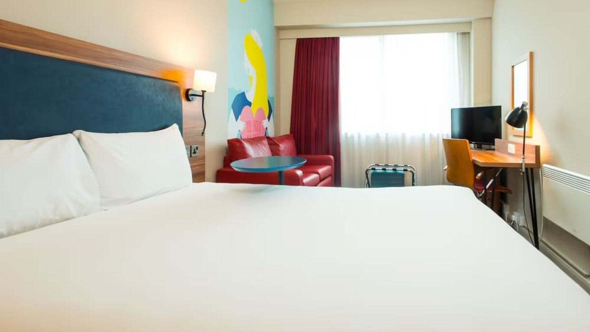 Day use room with work desk and sofa at ibis Styles Birmingham NEC.