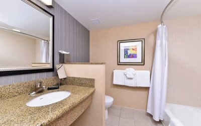 Guest bathroom with shower and tub at Courtyard By Marriott Boise West/Meridian.