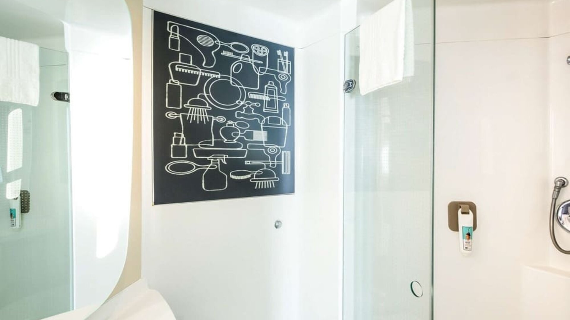 Guest bathroom with shower and free toiletries at Ibis Birmingham Bordesley.