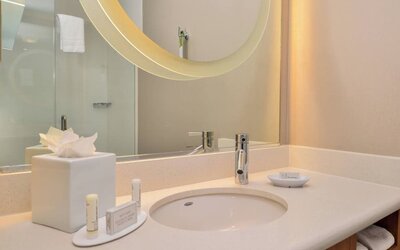 Guest bathroom with shower at SpringHill Suites By Marriott Irvine John Wayne Airport/Orange County.