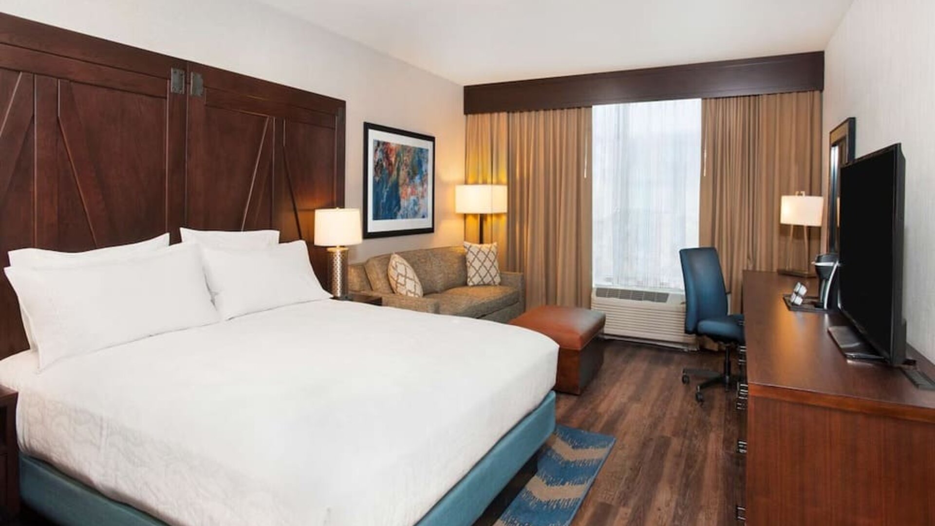 Day use room with work desk and sofa at Hilton Garden Inn Burbank Downtown.